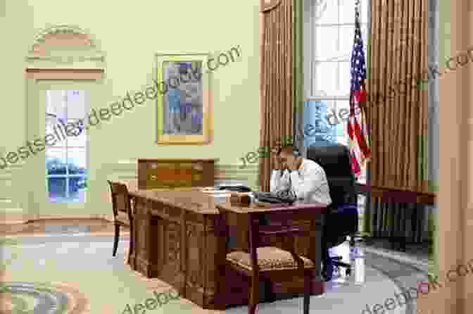 Barack Obama Sitting At A Desk In The Oval Office, Smiling And Holding A Pen. The Desk Is Covered With Papers And Books. A Window In The Background Looks Out Onto The White House Lawn. Hope And History: A Memoir Of Tumultuous Times